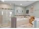 Elegant bathroom featuring a luxurious soaking tub and a separate glass-enclosed shower at 13810 Lake Village Pl, Tampa, FL 33618