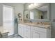 Bathroom with double vanity, granite counters, stylish fixtures, and ample natural light at 13810 Lake Village Pl, Tampa, FL 33618
