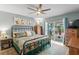 Comfortable bedroom with ceiling fan and sliding glass door to screened lanai at 13810 Lake Village Pl, Tampa, FL 33618