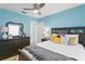 Inviting bedroom with blue walls and a dark wood dresser and headboard at 13810 Lake Village Pl, Tampa, FL 33618