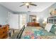 Comfortable bedroom with an ensuite bathroom, dresser, chair, and view to bathroom at 13810 Lake Village Pl, Tampa, FL 33618