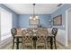 Cozy dining room with stylish chairs, a decorative rug, and ample natural light from window at 13810 Lake Village Pl, Tampa, FL 33618