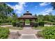 Charming gazebo surrounded by lush landscaping, providing a peaceful retreat in a community park setting at 13810 Lake Village Pl, Tampa, FL 33618