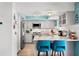 Well-lit kitchen with stainless steel appliances, ample counter space, and breakfast bar with seating at 13810 Lake Village Pl, Tampa, FL 33618