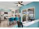 Bright kitchen with eat-in bar area, stainless appliances, and view of screened pool and patio at 13810 Lake Village Pl, Tampa, FL 33618