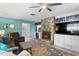 Living room featuring a stone fireplace, built-in bar, comfortable seating and a ceiling fan at 13810 Lake Village Pl, Tampa, FL 33618