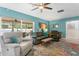 Spacious living room with comfortable seating, ceiling fan and sliding glass door at 13810 Lake Village Pl, Tampa, FL 33618