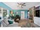 Cozy living room with an eye-catching stone fireplace, ceiling fan and comfortable seating at 13810 Lake Village Pl, Tampa, FL 33618
