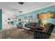 Spacious living room with comfortable seating, colorful rug, and seamless flow to the kitchen at 13810 Lake Village Pl, Tampa, FL 33618