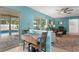 Bright living room with a pool view, ceiling fan, and comfortable seating at 13810 Lake Village Pl, Tampa, FL 33618