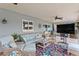 Covered patio with comfortable seating and an outdoor television at 13810 Lake Village Pl, Tampa, FL 33618