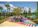 Vibrant rest area with colorful ground art, benches, and trees providing a relaxing outdoor space at 13810 Lake Village Pl, Tampa, FL 33618
