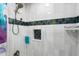Detailed view of a tile shower with a built-in niche and decorative accents at 13810 Lake Village Pl, Tampa, FL 33618