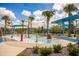 Interactive splash pad with water features and shaded seating areas, perfect for to cool off and play at 13810 Lake Village Pl, Tampa, FL 33618