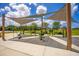 Outdoor workout area under shade sails with green exercise equipment and open space for fitness and recreation at 13810 Lake Village Pl, Tampa, FL 33618
