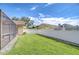 Lush green backyard featuring a privacy fence and access to screened-in patio at 13903 Wolcott Dr, Tampa, FL 33624