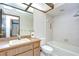 Bathroom featuring a sink and vanity and bathtub-shower combo with white tiling at 13903 Wolcott Dr, Tampa, FL 33624