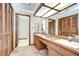 Bathroom featuring a dual sink vanity with a large mirror and ample cabinet space at 13903 Wolcott Dr, Tampa, FL 33624