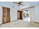 Cozy bedroom featuring a ceiling fan, neutral carpet, and sliding glass doors to outside at 13903 Wolcott Dr, Tampa, FL 33624