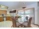 Cozy dining area adjacent to the kitchen with sliding glass doors leading to the screened pool at 13903 Wolcott Dr, Tampa, FL 33624
