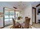 This dining area features a glass top table, seating for four, and views of the screened pool at 13903 Wolcott Dr, Tampa, FL 33624
