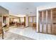 Foyer with tile flooring, leading to the dining room and featuring closet storage at 13903 Wolcott Dr, Tampa, FL 33624