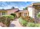 Brick walkway leads to a quaint entrance with natural wood double doors and verdant landscaping at 13903 Wolcott Dr, Tampa, FL 33624