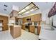 Well-lit kitchen featuring stainless steel appliances, ample counter space, and light wood cabinetry at 13903 Wolcott Dr, Tampa, FL 33624