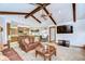 View of the living room showcasing the exposed wooden beams, fireplace, and open floor plan at 13903 Wolcott Dr, Tampa, FL 33624