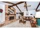 The living room features exposed wooden beams, a brick fireplace, and seamless integration with the adjacent kitchen at 13903 Wolcott Dr, Tampa, FL 33624