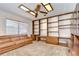 Spacious living room with a large window, built-in bookshelves, and a comfortable leather couch at 13903 Wolcott Dr, Tampa, FL 33624