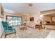 Cozy living room with plush seating, a glass table, and views of the screened-in pool at 13903 Wolcott Dr, Tampa, FL 33624