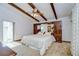 Bright main bedroom featuring exposed beams and large built-in wardrobe at 13903 Wolcott Dr, Tampa, FL 33624