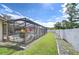A relaxing screened-in pool offers a private escape with a meticulously kept lawn and privacy fence at 13903 Wolcott Dr, Tampa, FL 33624