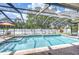 Enclosed pool with brick surround, lush landscaping, and spa for relaxation and outdoor enjoyment at 13903 Wolcott Dr, Tampa, FL 33624