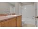 Bathroom with tub and shower combo and traditional cabinets and vanity at 16137 Churchview Dr, Lithia, FL 33547