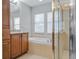 Well-lit bathroom featuring a tub, glass-enclosed shower, and granite countertops at 16137 Churchview Dr, Lithia, FL 33547