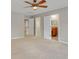 Bedroom with carpet, ceiling fan, multiple doors to closet, bathroom, and hallway at 16137 Churchview Dr, Lithia, FL 33547