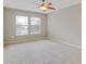 Neutral bedroom with carpet and ceiling fan featuring two windows at 16137 Churchview Dr, Lithia, FL 33547