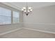 Dining room showcasing chandelier, wainscoting, and neutral paint at 16137 Churchview Dr, Lithia, FL 33547