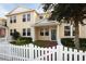 Charming two-story home with yellow siding, white picket fence, and well-maintained landscaping at 16137 Churchview Dr, Lithia, FL 33547