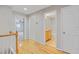 Bright hallway featuring wood floors leading to bedrooms, bathrooms and closets at 16137 Churchview Dr, Lithia, FL 33547