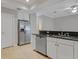 Kitchen featuring stainless steel appliances, granite countertops, white cabinets, and tiled flooring at 16137 Churchview Dr, Lithia, FL 33547