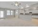 Open-concept living and kitchen area with tiled floors in the kitchen and white cabinets at 16137 Churchview Dr, Lithia, FL 33547
