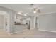 Spacious living room showing open floor plan flowing into kitchen with stainless steel appliances at 16137 Churchview Dr, Lithia, FL 33547
