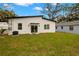 Home's backyard features a modern exterior, a lush lawn and a sliding glass door for indoor/outdoor living at 1625 39Th S St, St Petersburg, FL 33711