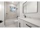 Elegant bathroom featuring marble tile, a modern vanity, and a bathtub at 1625 39Th S St, St Petersburg, FL 33711