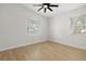 Bright bedroom with light wood floors, fan, and two windows that provide natural light at 1625 39Th S St, St Petersburg, FL 33711