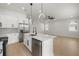 Modern kitchen featuring an island with a sink, stainless steel appliances, and pendant lighting at 1625 39Th S St, St Petersburg, FL 33711