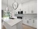 Well-lit kitchen with white cabinets, marble countertops, and a modern faucet at 1625 39Th S St, St Petersburg, FL 33711